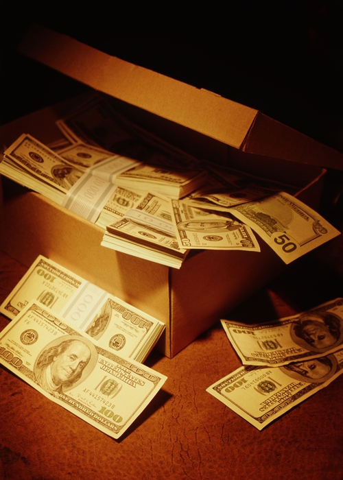 Old Cardboard Shoebox Overflowing with Money