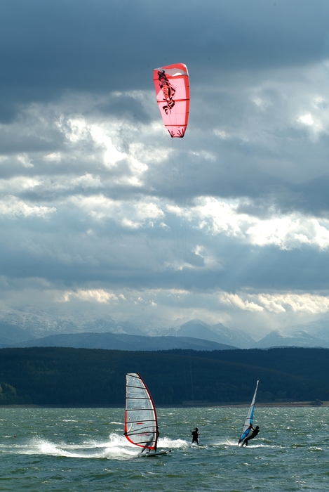 Windsurfers and Kitesurfer Catching Air