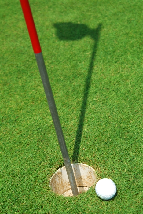 Golf Ball on The Edge of The Cup