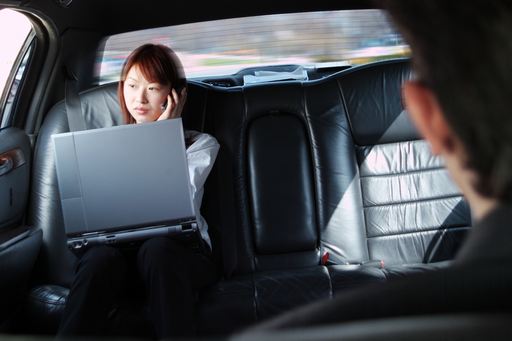 Businesswoman Working in a Limousine