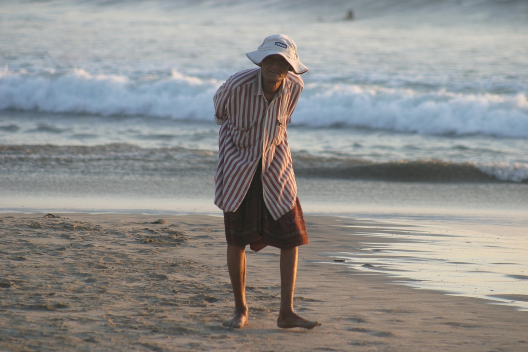 Old Man Walking on The Beach