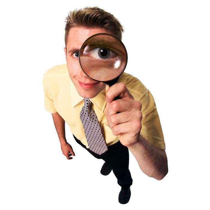 Man Looking Through a Magnifying Glass