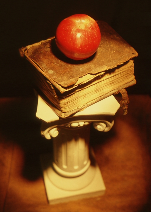 Pedestal with Very Old Book and Apple