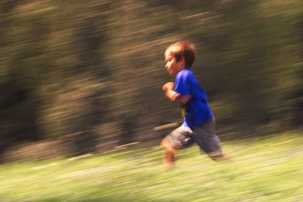 Boy Running in The Grass
