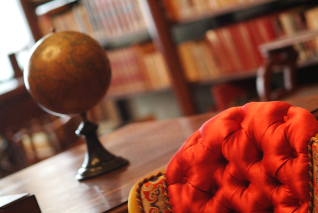 Library Setting with Books, Chair and a Globe