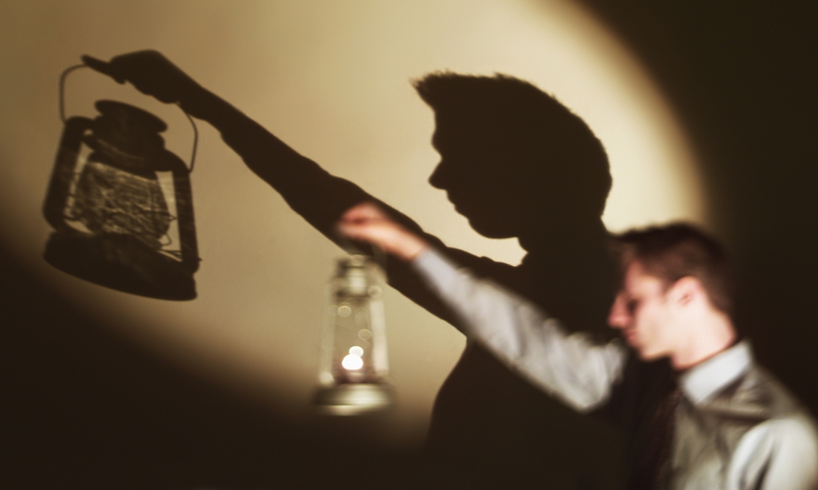 Businessman with An Oil Lamp with Shadow