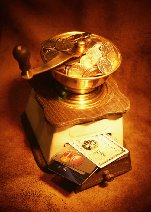 Coffee Grinder with Coins on Top Spilling Out Credit Cards