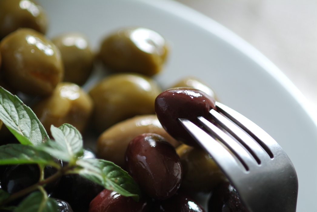 Fresh Olives with Fork and Basil