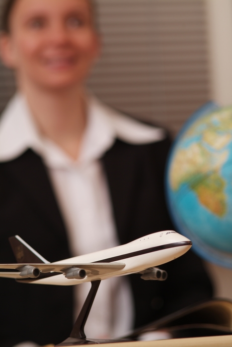 Travel Agent with Model Airplane and Globe