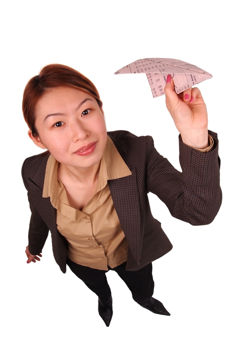 Businesswoman Throwing a Paper Airplane