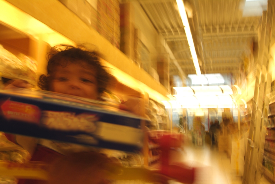 Child Pushing Grocery Cart at Supermarket