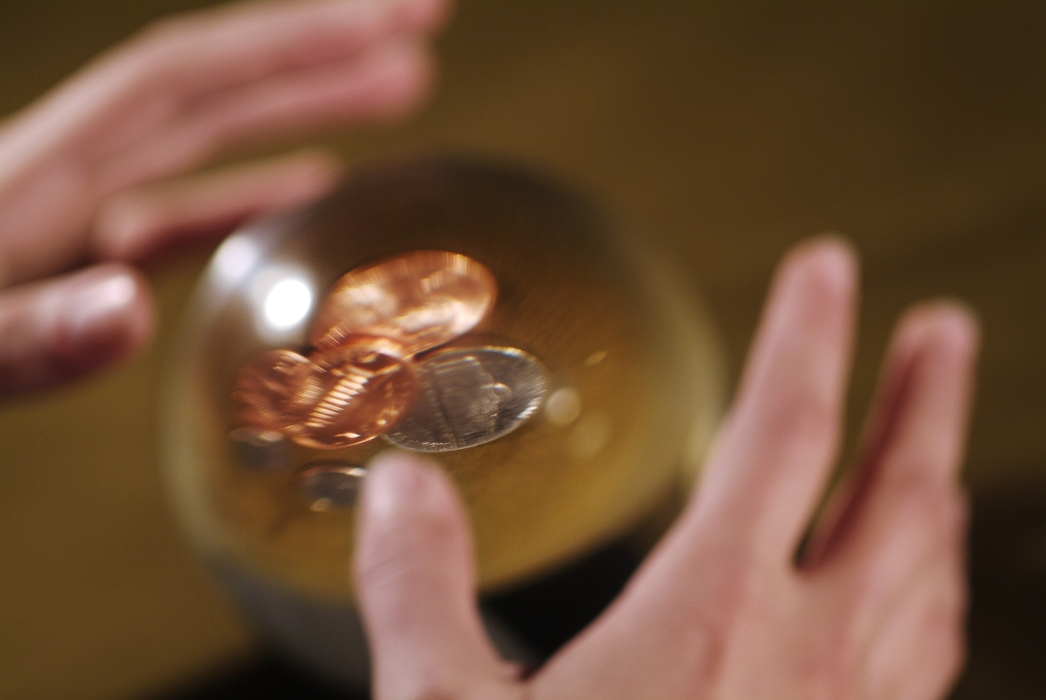 Hands and Crystal Ball with Coins Inside